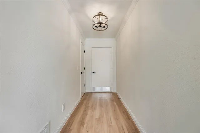 a view of a room with wooden floor