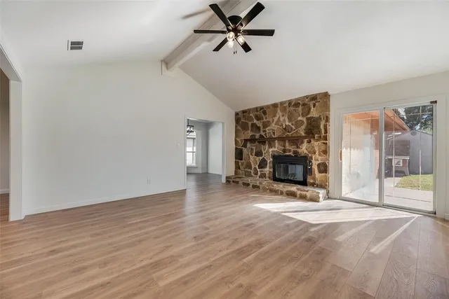a view of a livingroom with a fireplace and window
