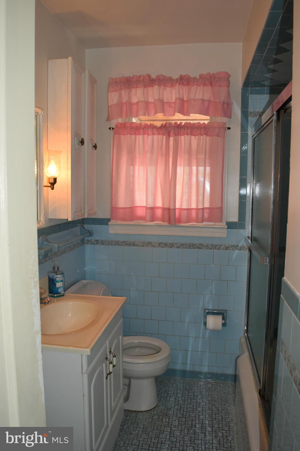 1529 Leslie Road Baltimore, MD 21222 - Photo 13 of 23 a bathroom with a sink a toilet and a mirror