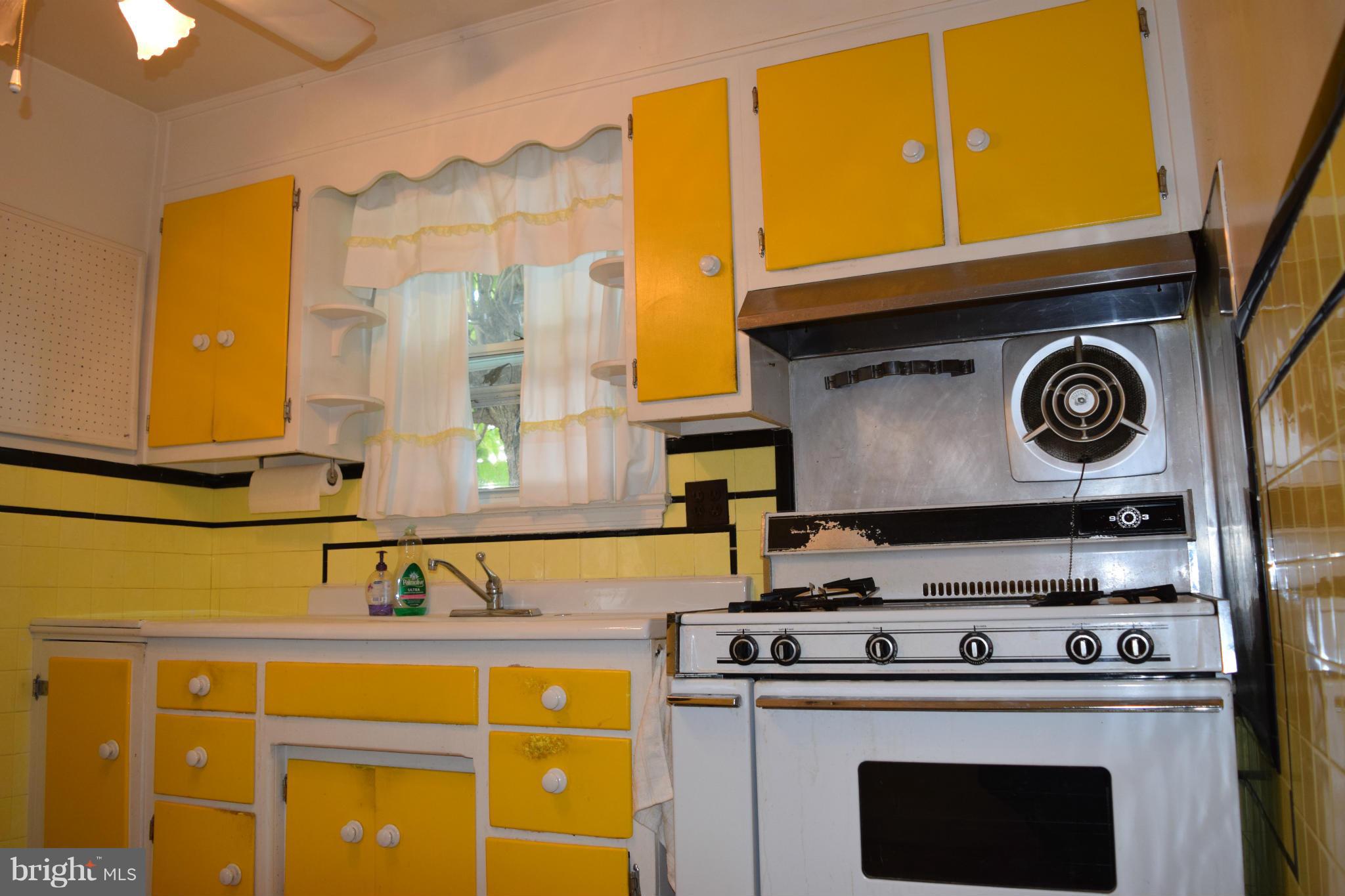1529 Leslie Road Baltimore, MD 21222 - Photo 15 of 23 a kitchen with a stove and a microwave