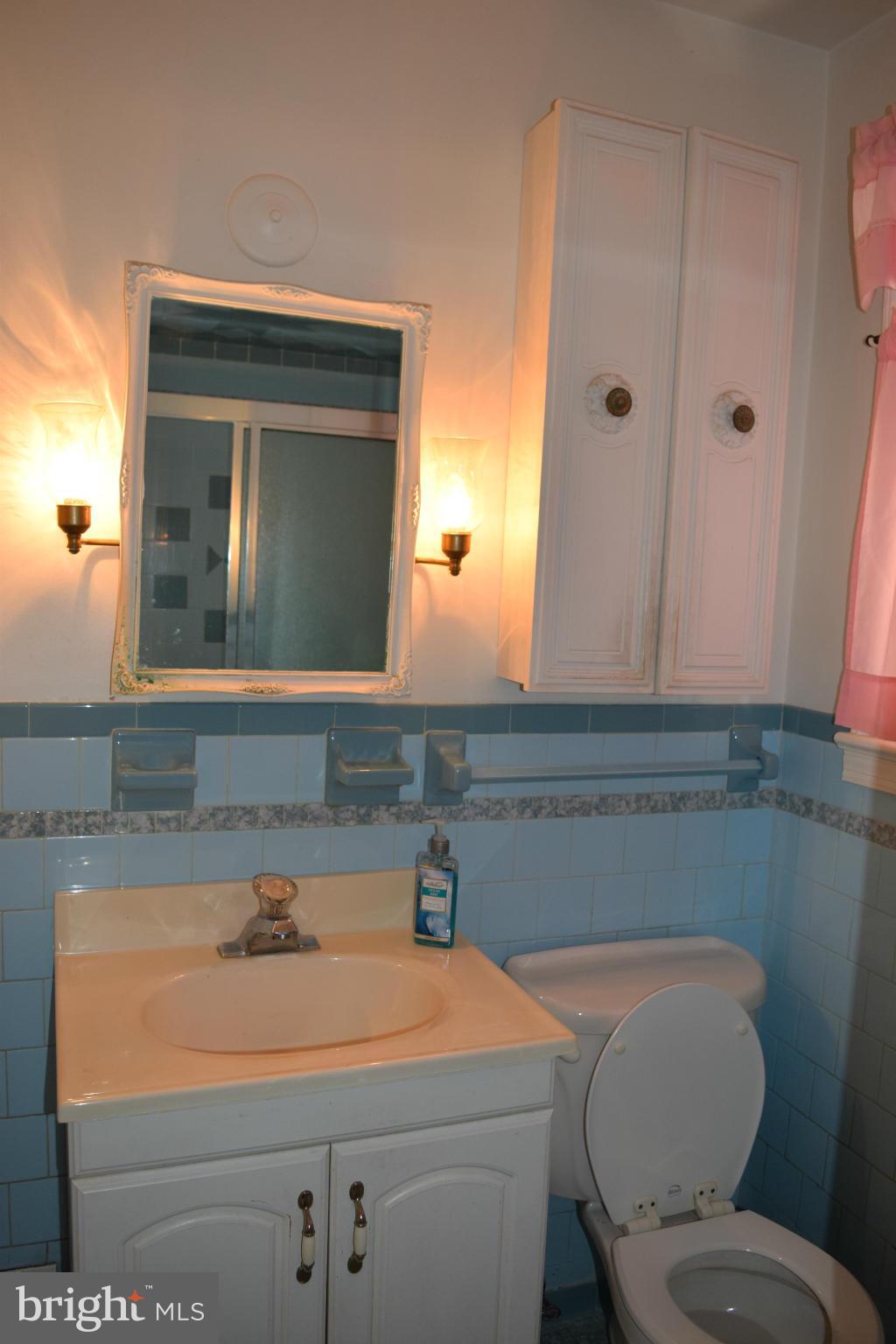 1529 Leslie Road Baltimore, MD 21222 - Photo 6 of 23 a bathroom with a toilet sink and mirror