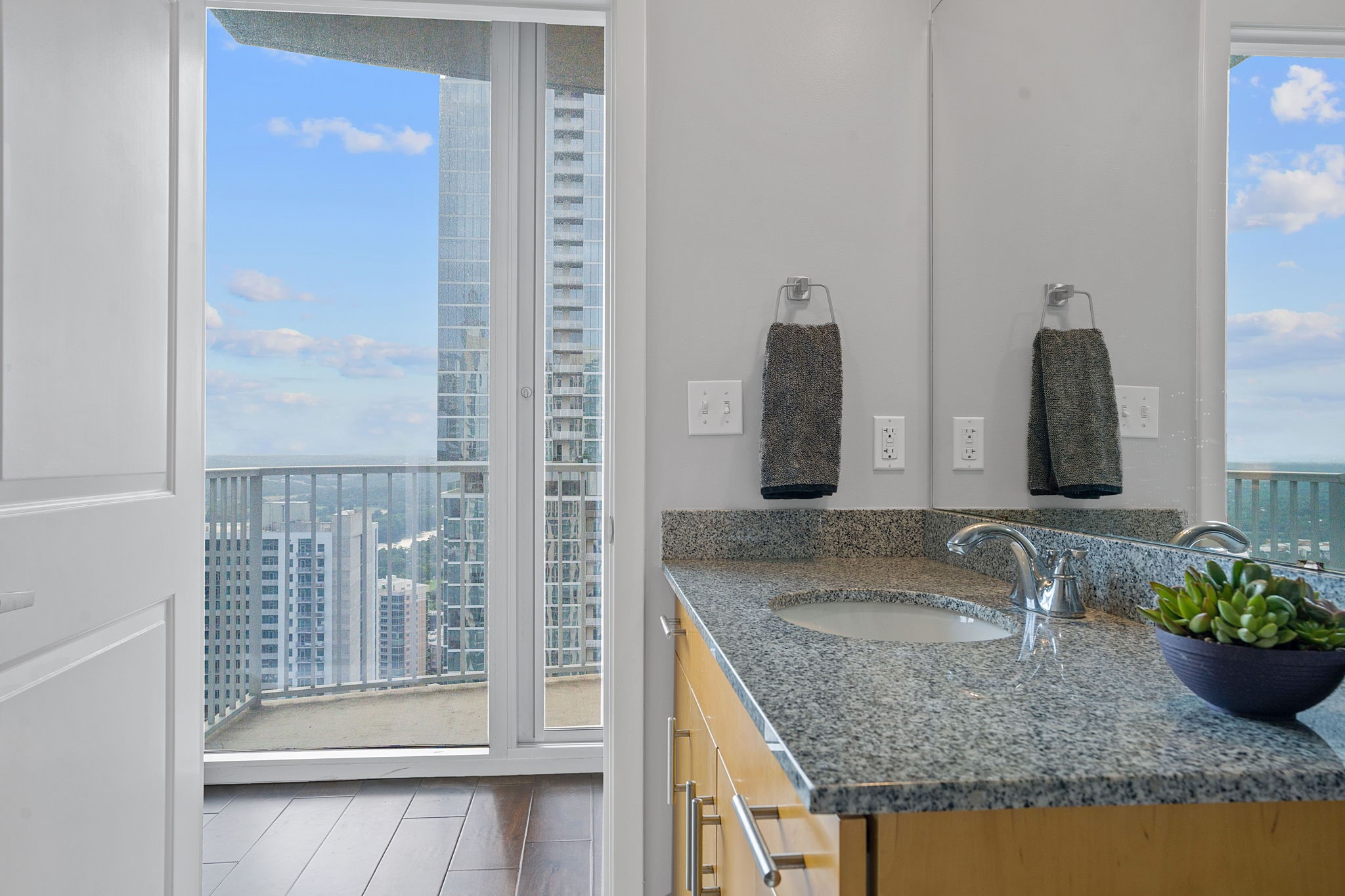 360 Nueces Street, Unit 3608 Austin, TX 78701 - Photo 16 of 40 a bathroom with granite countertop a sink and a mirror