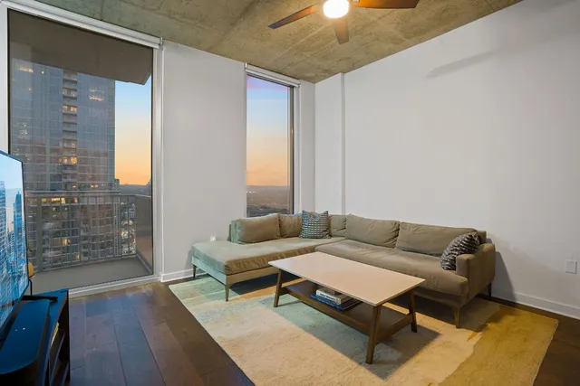 a living room with furniture and wooden floor