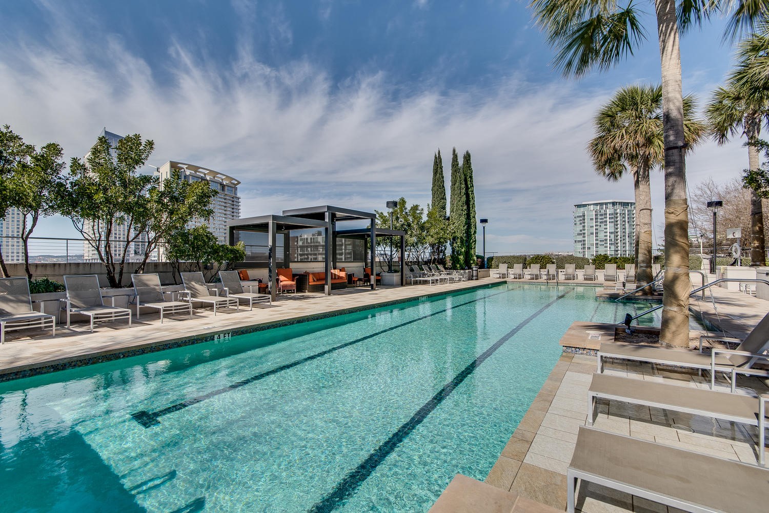 360 Nueces Street, Unit 3608 Austin, TX 78701 - Photo 31 of 40 a view of swimming pool with outdoor seating and house in the background