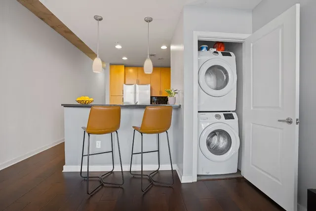 a view of a storage and utility room with washer and dryer