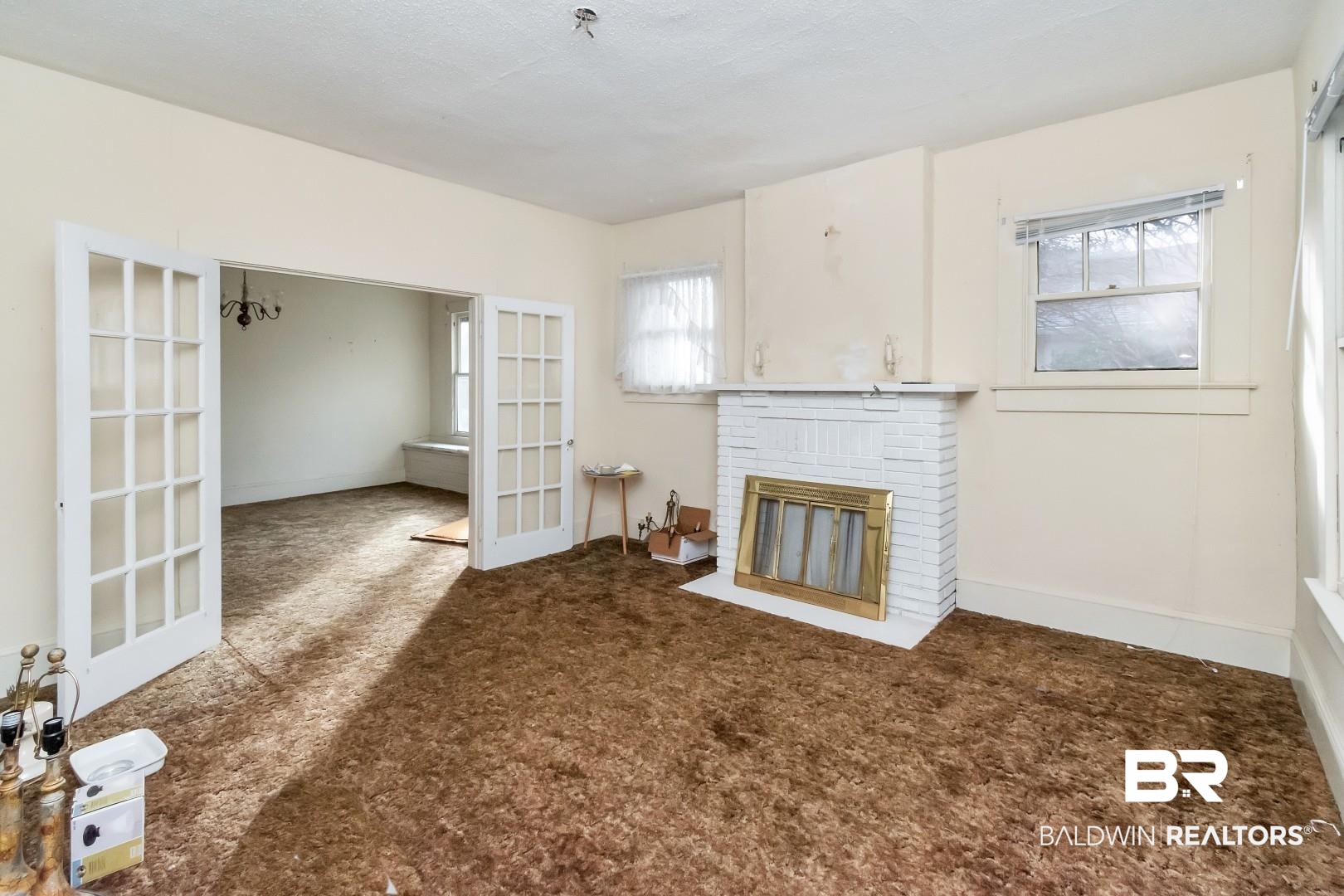 4305 Stein Street Mobile, AL 36608 - Photo 6 of 22 Unfurnished living room with a fireplace, french doors, and carpet floors