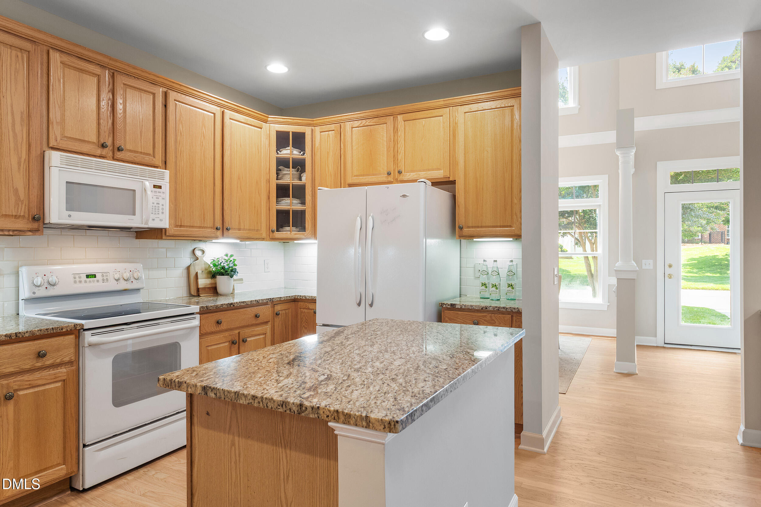 4724 Ludwell Branch Court Raleigh, NC 27612 - Photo 10 of 72 a kitchen with stainless steel appliances granite countertop a refrigerator and a stove top oven