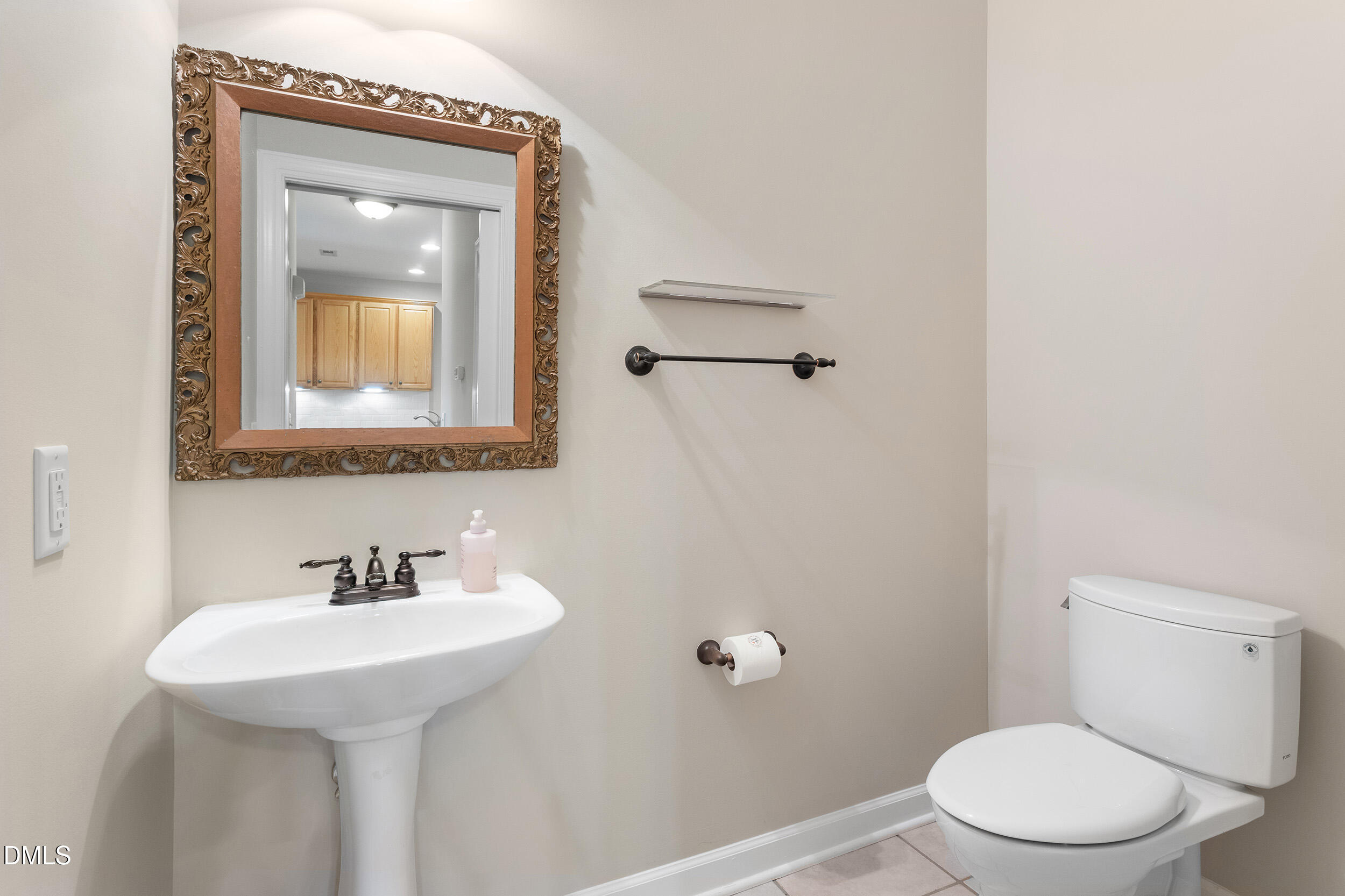 4724 Ludwell Branch Court Raleigh, NC 27612 - Photo 16 of 72 a bathroom with a toilet sink and mirror