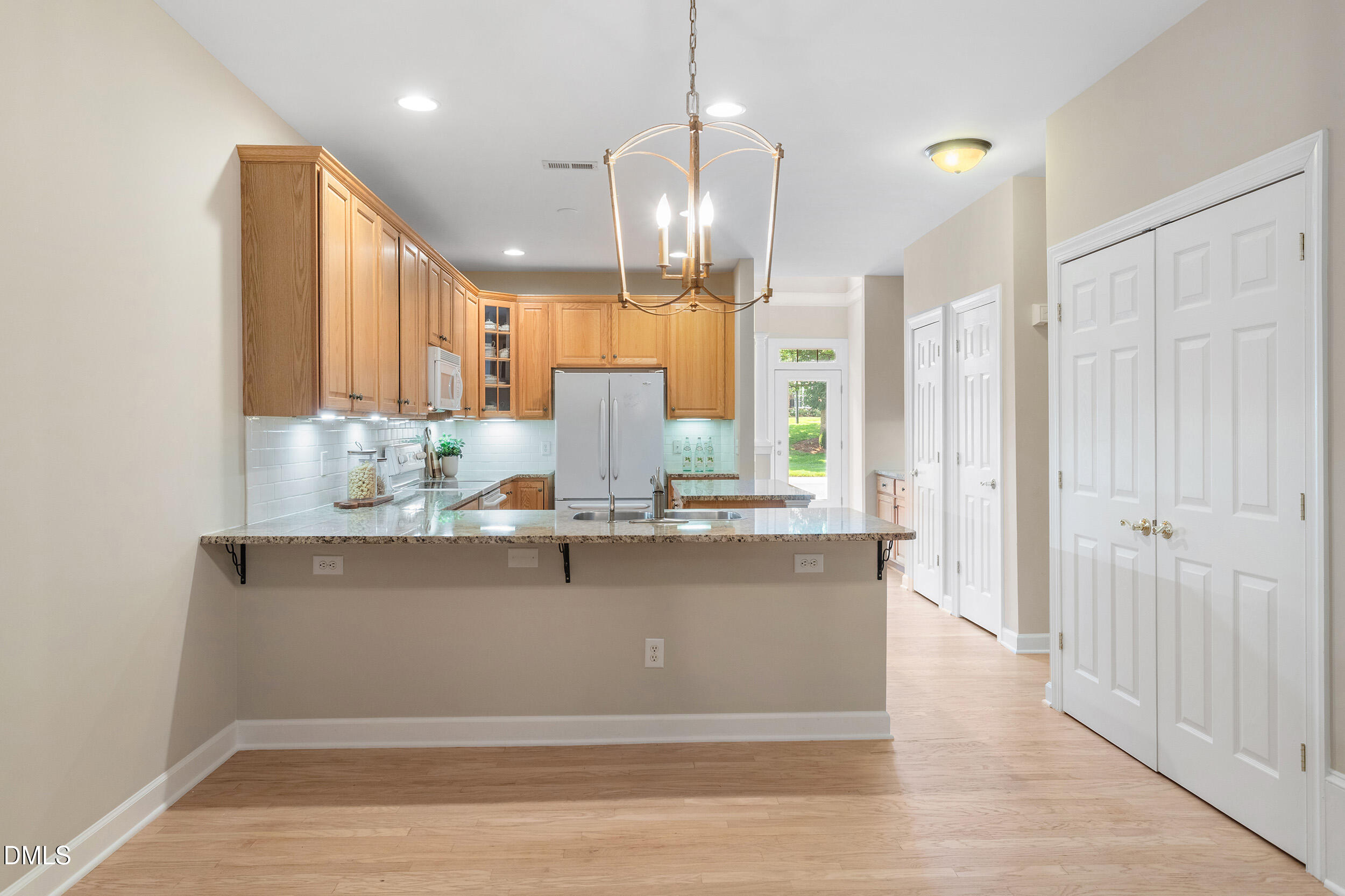 4724 Ludwell Branch Court Raleigh, NC 27612 - Photo 20 of 72 a view of kitchen with stainless steel appliances granite countertop cabinets and window