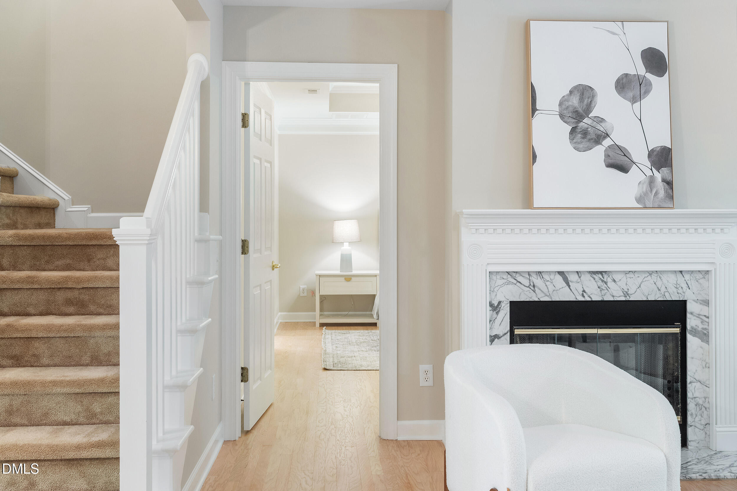 4724 Ludwell Branch Court Raleigh, NC 27612 - Photo 33 of 72 a living room with a fireplace and a painting on the wall