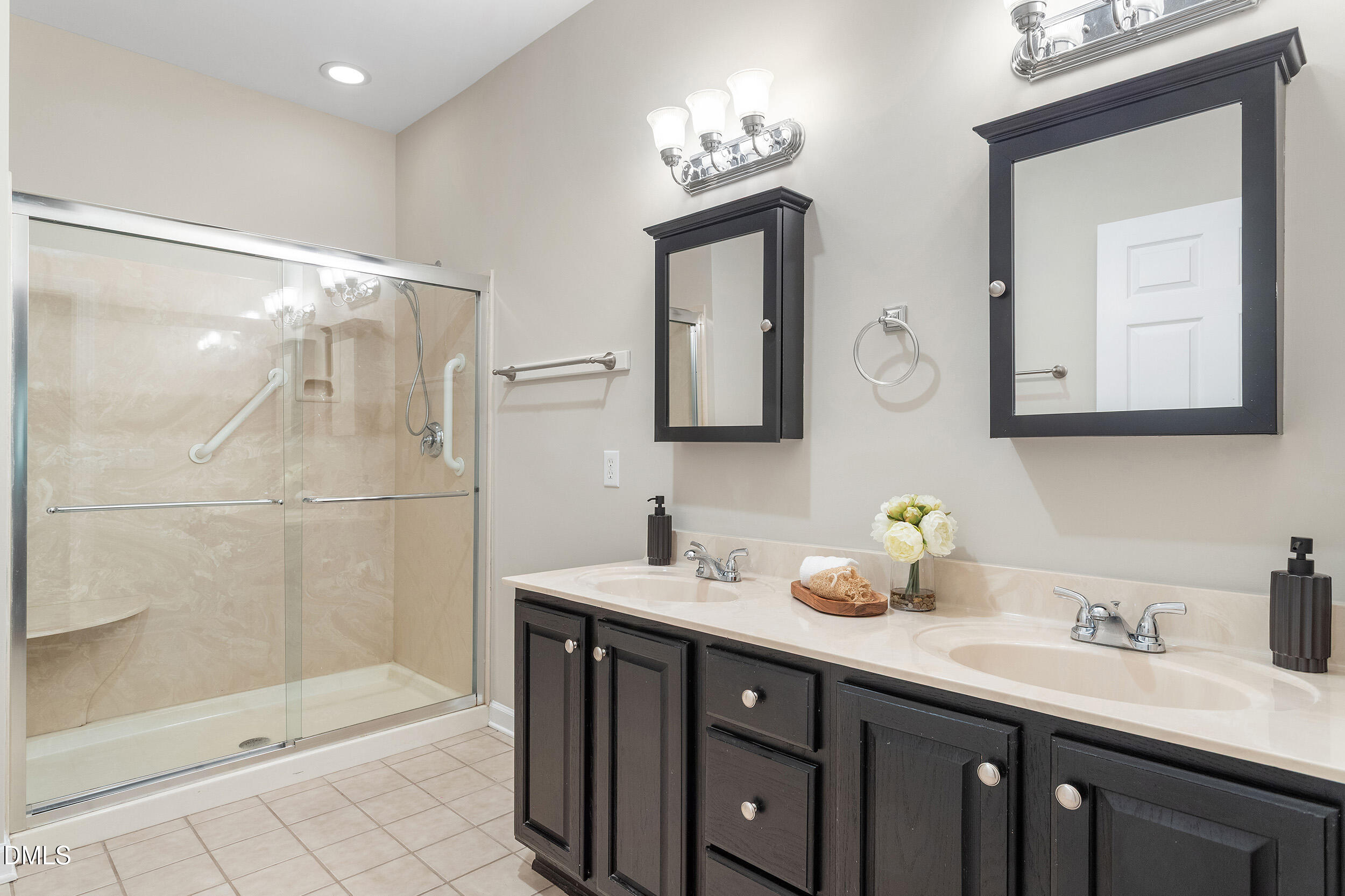 4724 Ludwell Branch Court Raleigh, NC 27612 - Photo 41 of 72 a bathroom with a double vanity sink mirror and shower