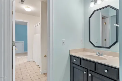 a view of a swimming pool with a patio table and chairs