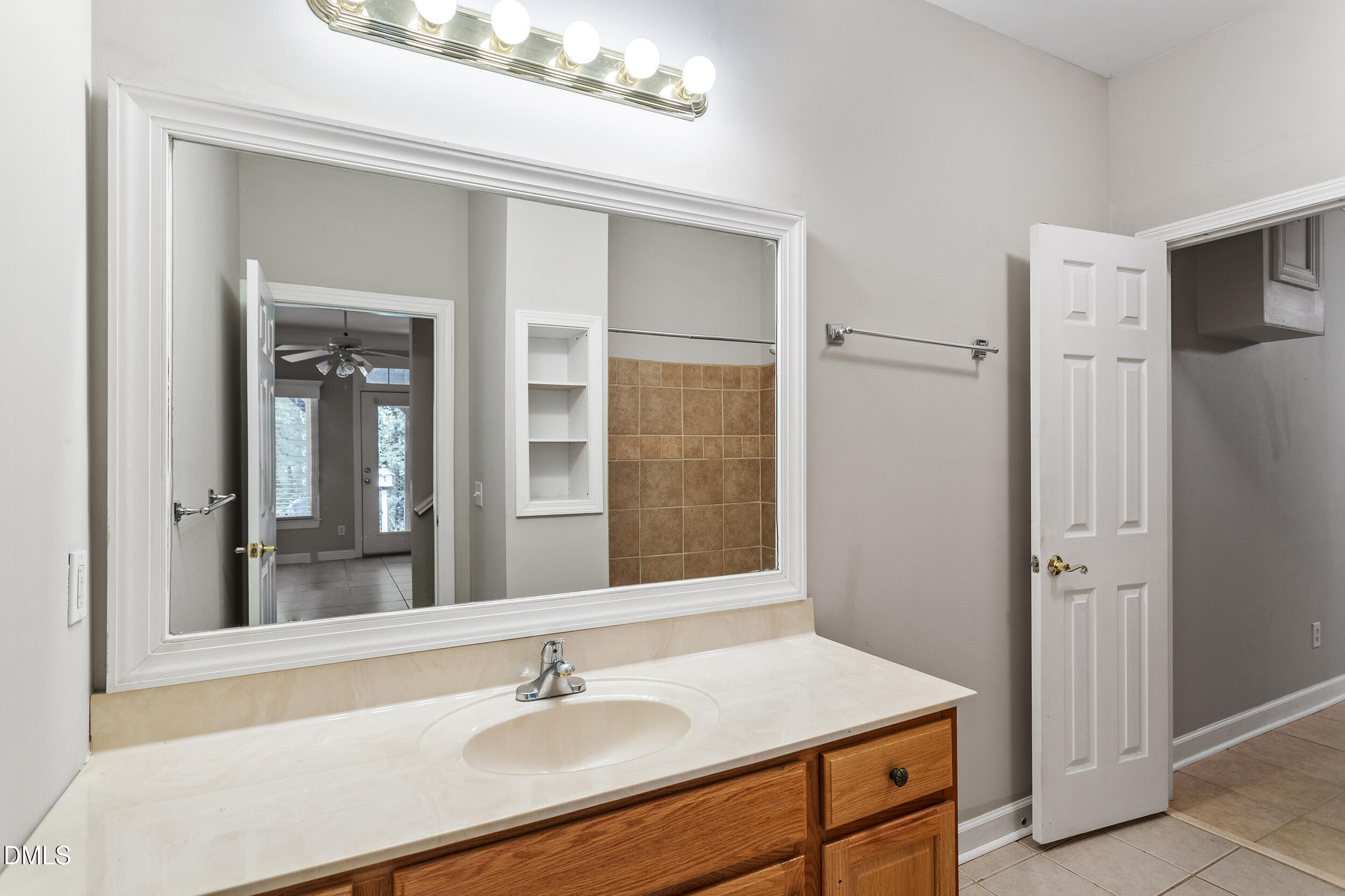 4724 Ludwell Branch Court Raleigh, NC 27612 - Photo 59 of 72 a bathroom with a sink vanity granite and a mirror