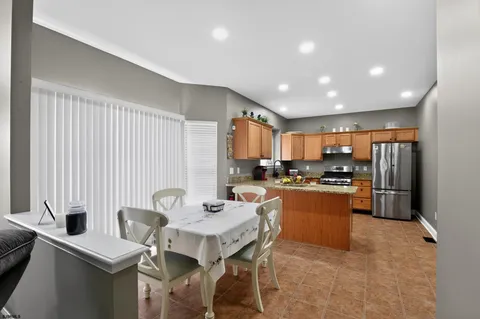 a kitchen with stainless steel appliances kitchen island granite countertop a sink and cabinets
