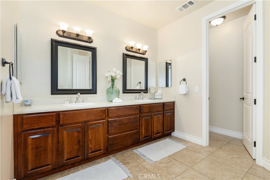 669 Red Cloud Road Paso Robles, CA 93446 - Photo 23 of 61 a spacious bathroom with a double vanity sink double and mirror