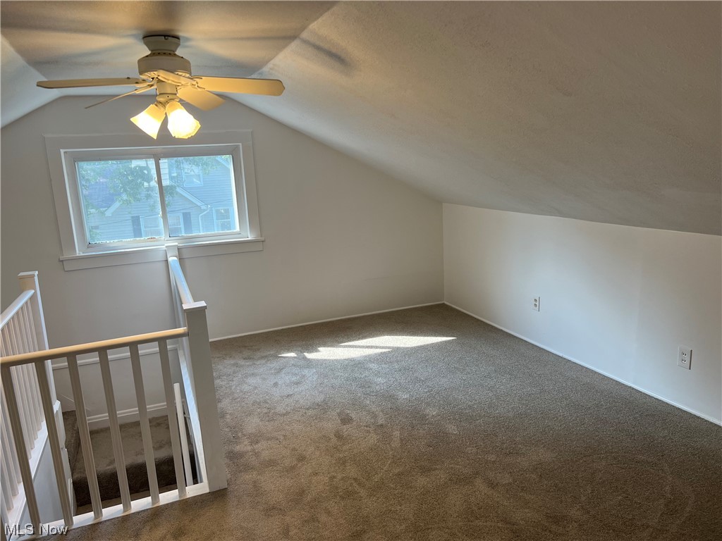 1609 Lyndhurst Road Lyndhurst, OH 44124 - Photo 25 of 34 Additional living space with vaulted ceiling, dark carpet, and ceiling fan