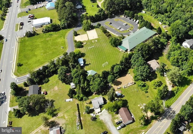 an aerial view of a house with a yard swimming pool