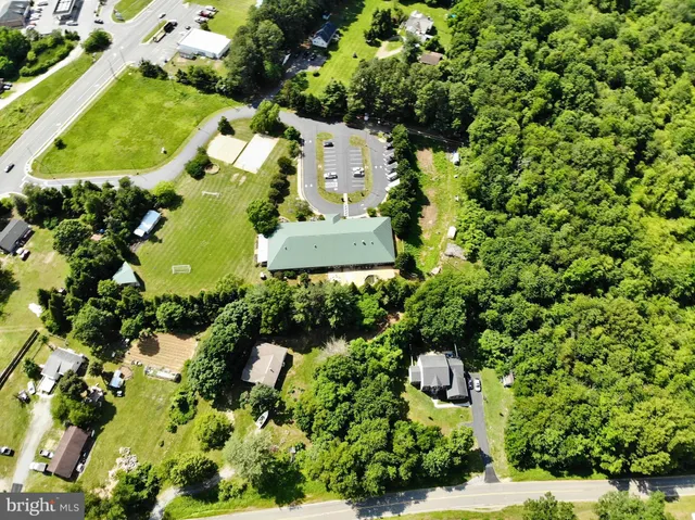 an aerial view of a residential houses with yard