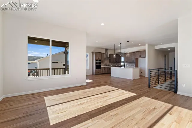 a spacious bedroom with a bed and a dresser