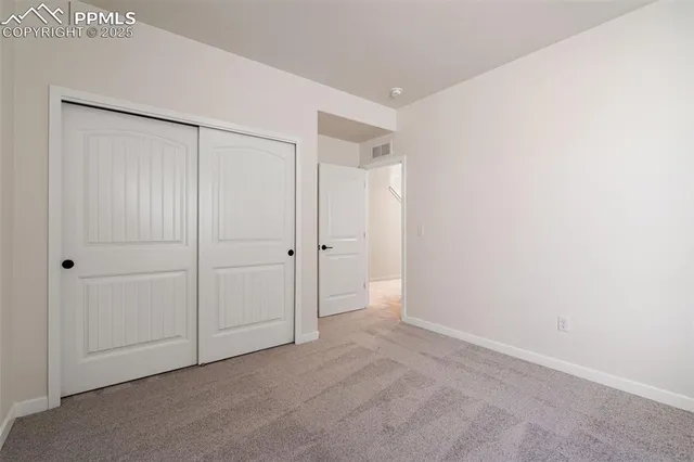 a view of an house with backyard and trees