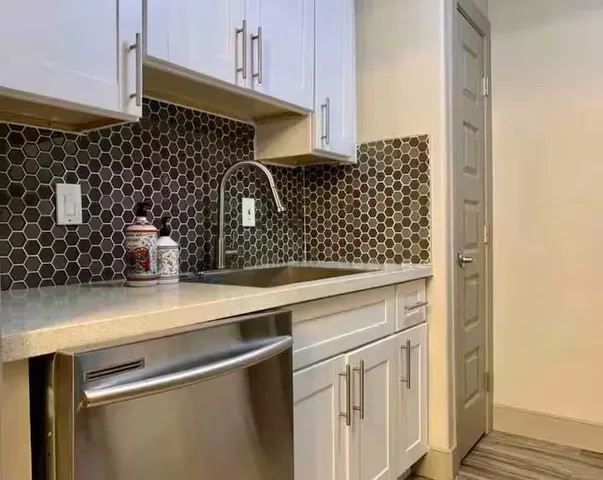 a kitchen with a sink and cabinets