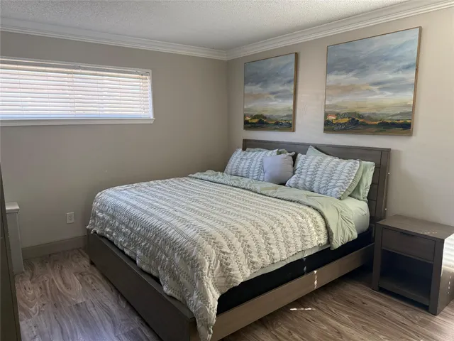 a large bed sitting in a bedroom next to a window