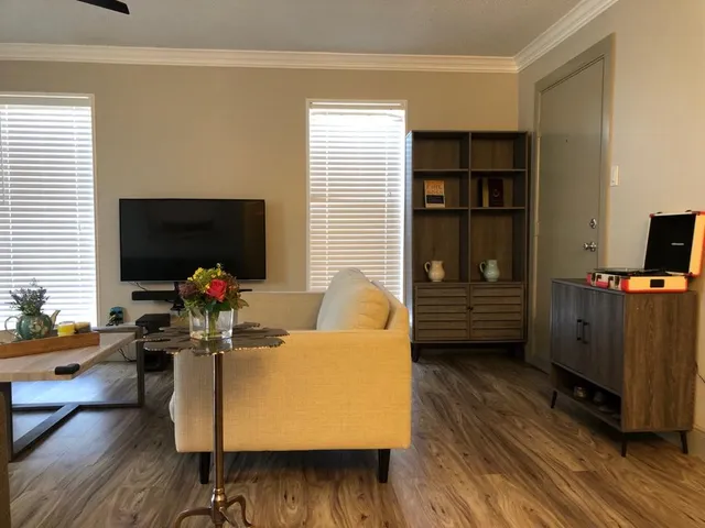 a living room with furniture and a flat screen tv