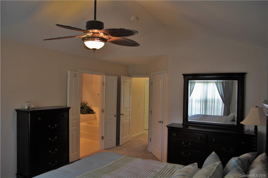3908 Caliper Place, Unit 325 Fort Mill, SC 29708 - Photo 14 of 24 a bedroom with a bed and a dresser