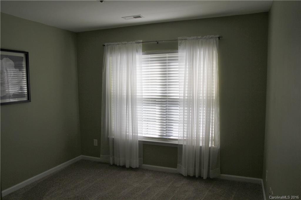 3908 Caliper Place, Unit 325 Fort Mill, SC 29708 - Photo 20 of 24 a view of an empty room with a window