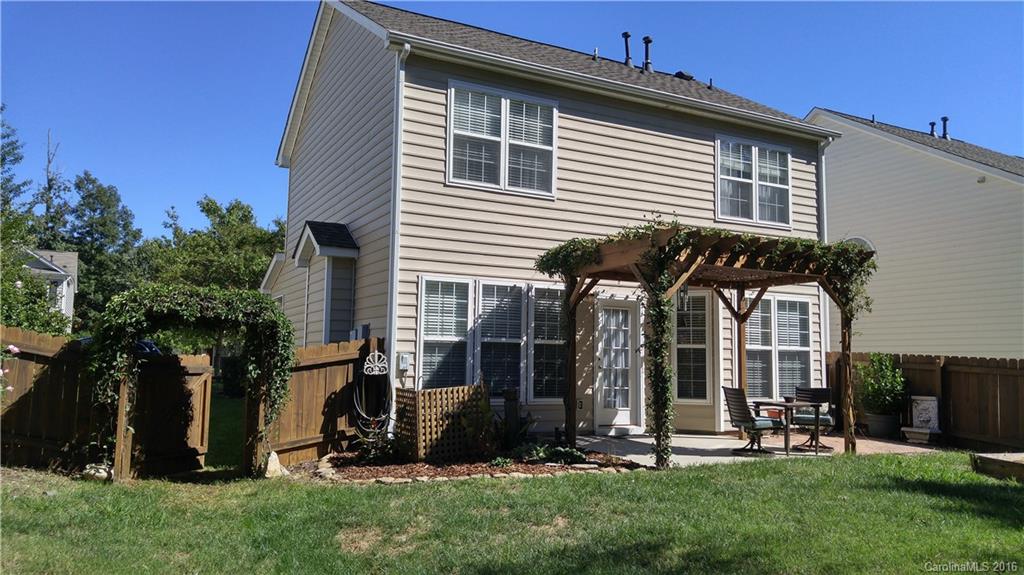 3908 Caliper Place, Unit 325 Fort Mill, SC 29708 - Photo 22 of 24 a view of a house with brick walls and a yard with plants