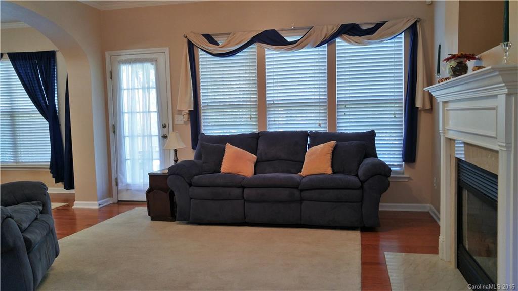 3908 Caliper Place, Unit 325 Fort Mill, SC 29708 - Photo 4 of 24 a living room with furniture a fireplace and a large window
