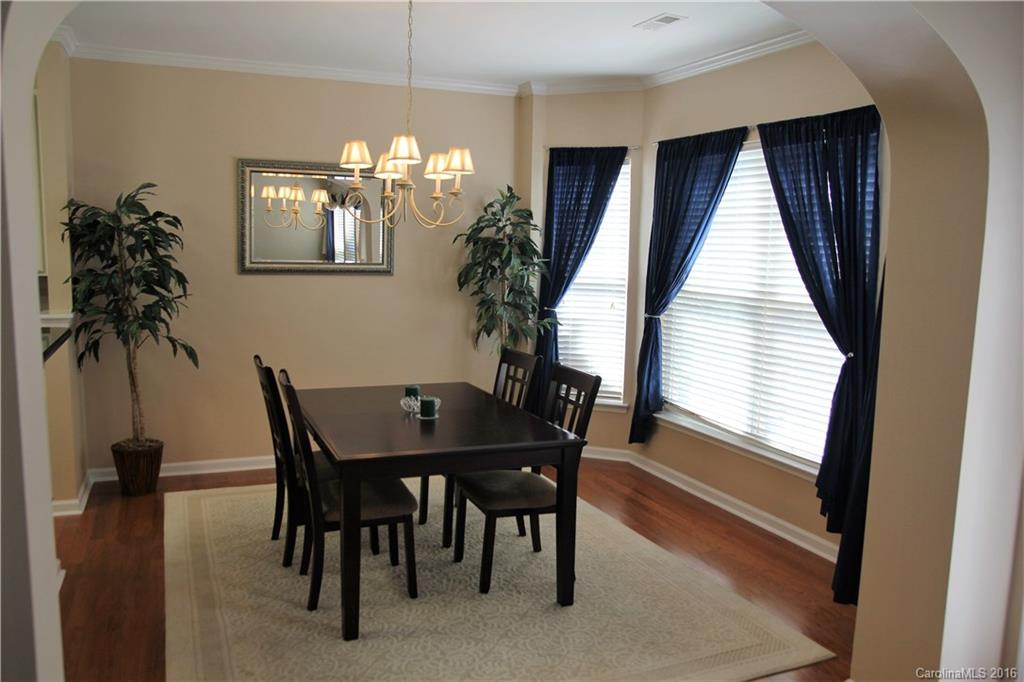 3908 Caliper Place, Unit 325 Fort Mill, SC 29708 - Photo 6 of 24 a view of a dining room with furniture and a chandelier