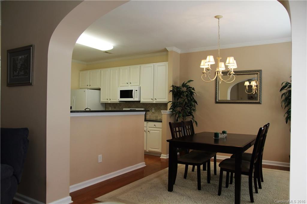 3908 Caliper Place, Unit 325 Fort Mill, SC 29708 - Photo 7 of 24 a kitchen with a table and chairs in it