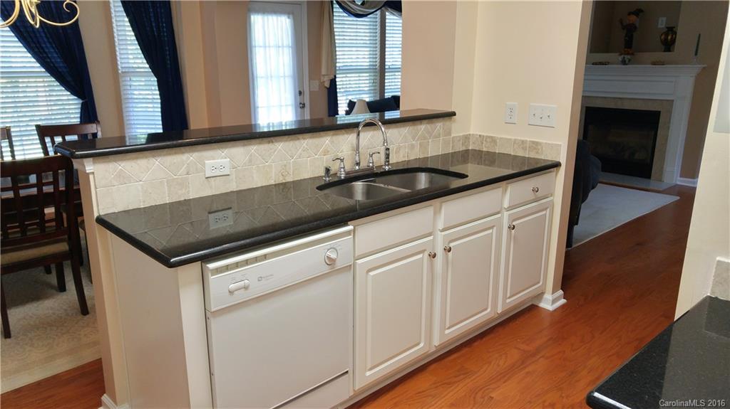 3908 Caliper Place, Unit 325 Fort Mill, SC 29708 - Photo 10 of 24 a kitchen with granite countertop a sink and cabinets