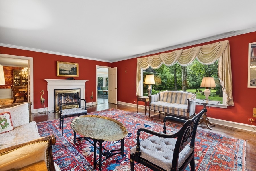 321 Oak Brook Road Oak Brook, IL 60523 - Photo 13 of 40 a living room with furniture a fireplace and a large window