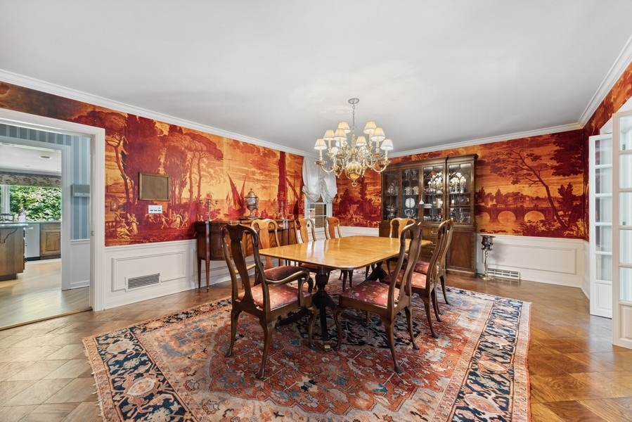 321 Oak Brook Road Oak Brook, IL 60523 - Photo 17 of 40 a view of a dining room with furniture a chandelier and wooden floor