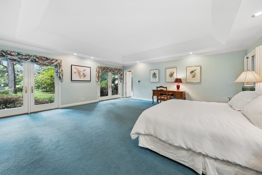321 Oak Brook Road Oak Brook, IL 60523 - Photo 20 of 40 a spacious bedroom with a bed and a large window