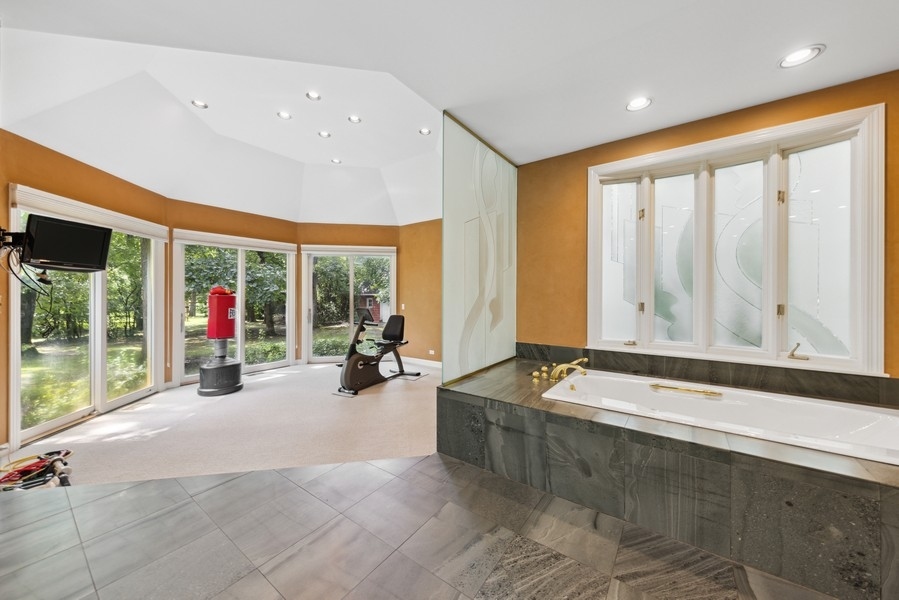 321 Oak Brook Road Oak Brook, IL 60523 - Photo 22 of 40 a view of a living room and floor to ceiling window and couch