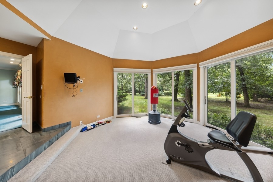 321 Oak Brook Road Oak Brook, IL 60523 - Photo 23 of 40 a view of a room with gym equipment and floor to ceiling window