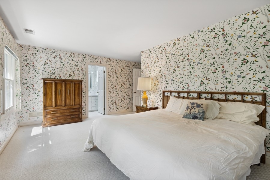 321 Oak Brook Road Oak Brook, IL 60523 - Photo 28 of 40 a bedroom with a large bed and wooden floor