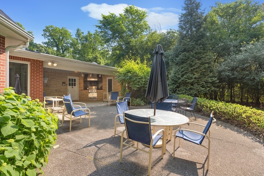 321 Oak Brook Road Oak Brook, IL 60523 - Photo 33 of 40 a view of a patio with table and chairs and potted plants