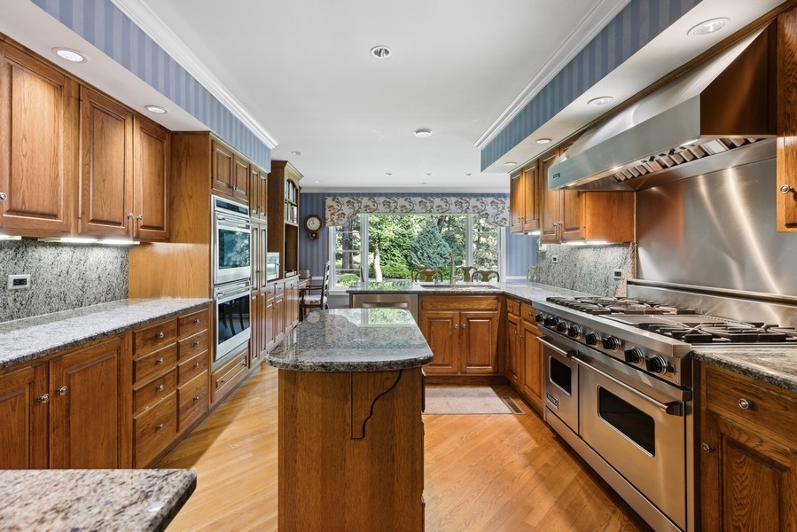 321 Oak Brook Road Oak Brook, IL 60523 - Photo 7 of 40 a kitchen with stainless steel appliances granite countertop a stove a sink dishwasher and a refrigerator
