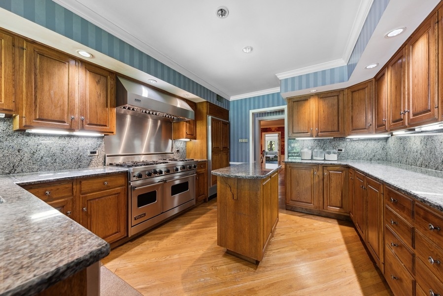 321 Oak Brook Road Oak Brook, IL 60523 - Photo 8 of 40 a kitchen with stainless steel appliances granite countertop a stove a sink and a microwave