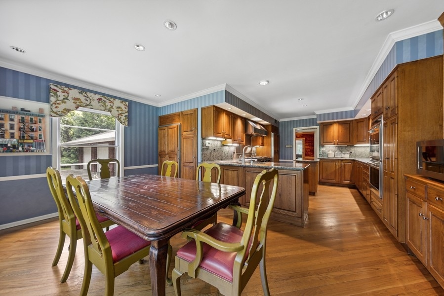 321 Oak Brook Road Oak Brook, IL 60523 - Photo 9 of 40 a dining room with furniture and wooden floor