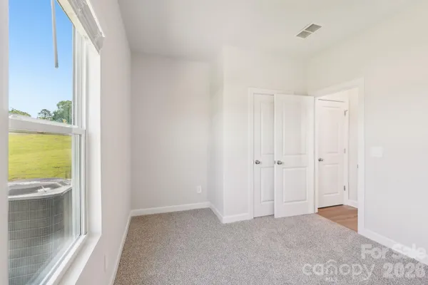 a view of an empty room and a window