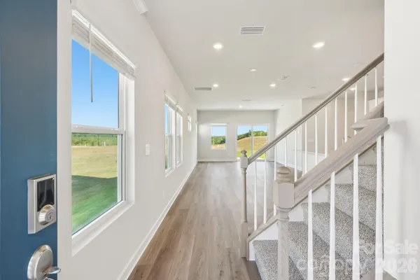 a view of entryway with wooden floor and windows