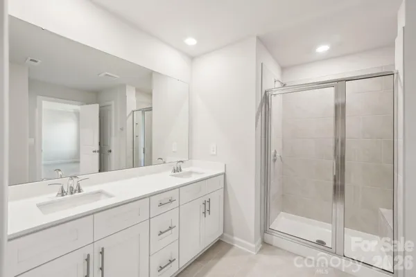 a bathroom with a double vanity sink mirror and double