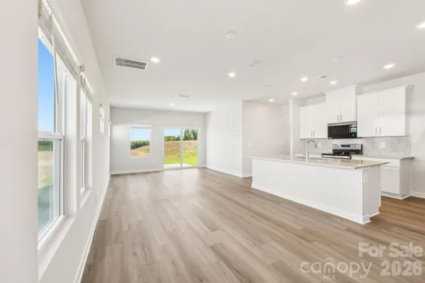 a view of kitchen with granite countertop cabinets and wooden floor