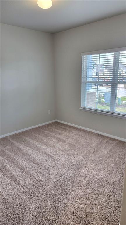 2741 Winding Creek Road Kyle, TX 78640 - Photo 6 of 11 Unfurnished room featuring baseboards and light colored carpet