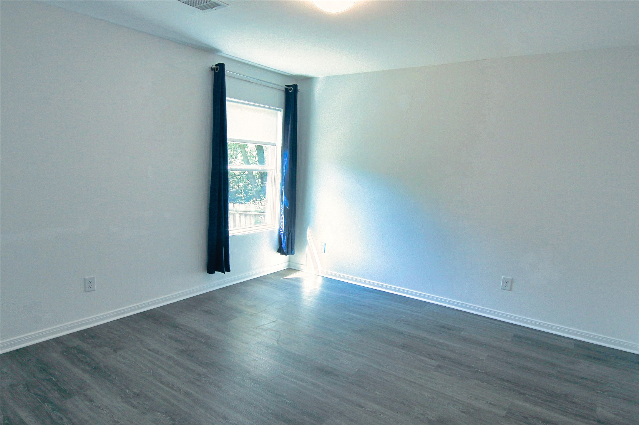 225 Basil Livingston, TX 77351 - Photo 11 of 22 a view of an empty room with wooden floor and a window